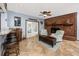 Open living area with brick fireplace, bar seating, and access to the outdoor pool area at 1975 Levine Ln, Clearwater, FL 33760