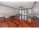Spacious living room with hardwood floors, cozy seating, and double doors to the backyard at 1975 Levine Ln, Clearwater, FL 33760