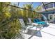 Private screened pool with covered lounge area and outdoor dining at 1975 Levine Ln, Clearwater, FL 33760