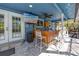 Outdoor kitchen featuring built-in cabinets, counter tops and a mounted television at 1975 Levine Ln, Clearwater, FL 33760