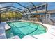 Enclosed pool area features a clear pool and surrounding patio at 1975 Levine Ln, Clearwater, FL 33760