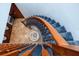 Elegant staircase featuring wood railing, newel post, and a luxurious blue runner at 1975 Levine Ln, Clearwater, FL 33760