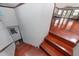 Stairway with beautiful wood floors leading to a spacious living area with natural light at 1975 Levine Ln, Clearwater, FL 33760