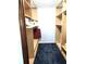 Walk-in closet with built-in wooden shelving and ample storage space for an organized wardrobe at 1975 Levine Ln, Clearwater, FL 33760