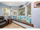 Bright window seat offers a relaxing space with decorative pillows and ample natural light at 1975 Levine Ln, Clearwater, FL 33760