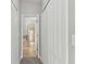 Hallway leading to the bathroom featuring tiled flooring and a view of the tub with glass door at 20426 Autumn Fern Ave, Tampa, FL 33647