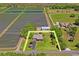 Aerial view of the property, highlighting its spacious lot, a well-maintained home, and a nearby barn at 2102 W Knights Griffin Rd, Plant City, FL 33565