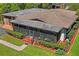 Aerial view of home featuring the screened-in porch, manicured landscaping, and patio at 2102 W Knights Griffin Rd, Plant City, FL 33565