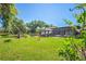 Expansive backyard with lush green lawn, patio, gazebo, and screened in porch at 2102 W Knights Griffin Rd, Plant City, FL 33565