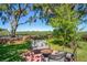 Inviting backyard patio area with chairs, table and firepit overlooking farm at 2102 W Knights Griffin Rd, Plant City, FL 33565
