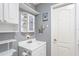 Bathroom with a white vanity, white cabinets, and decorative items including a vintage-style mirror at 2102 W Knights Griffin Rd, Plant City, FL 33565