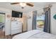 Inviting bedroom featuring wood-look floors, a ceiling fan, and plenty of natural light through the window at 2102 W Knights Griffin Rd, Plant City, FL 33565