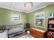 Charming Bedroom with two cribs, natural light, and plenty of space for the little ones to play and grow at 2102 W Knights Griffin Rd, Plant City, FL 33565