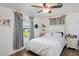 Bright bedroom featuring a comfortable bed with a headboard and natural light through the window at 2102 W Knights Griffin Rd, Plant City, FL 33565
