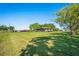 Well-maintained home with a sprawling lawn and mature trees, creating a serene and inviting atmosphere at 2102 W Knights Griffin Rd, Plant City, FL 33565