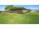 Charming home with a screened-in porch, surrounded by manicured hedges and a lush green lawn at 2102 W Knights Griffin Rd, Plant City, FL 33565