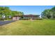Lovely home boasts a spacious yard, screened porch, and detached garage at 2102 W Knights Griffin Rd, Plant City, FL 33565