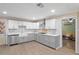 Modern kitchen features gray and white cabinetry and stainless steel appliances at 2102 W Knights Griffin Rd, Plant City, FL 33565