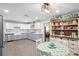 Bright kitchen features a stainless steel sink, white subway tile backsplash, and plenty of cabinet space for storage at 2102 W Knights Griffin Rd, Plant City, FL 33565