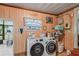 Well-equipped laundry room with modern appliances, storage and charming decor at 2102 W Knights Griffin Rd, Plant City, FL 33565