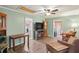 Comfortable living room with wood-look floors, a ceiling fan, and plenty of space for relaxing and entertaining at 2102 W Knights Griffin Rd, Plant City, FL 33565
