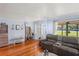 Comfortable living room boasts wood floors and convenient access to the outdoors at 2102 W Knights Griffin Rd, Plant City, FL 33565