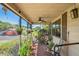 Inviting screened porch filled with lush plants and comfortable seating; perfect for relaxing and enjoying the outdoors at 2102 W Knights Griffin Rd, Plant City, FL 33565