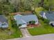 Back aerial view of property featuring screened in pool, fence, and luscious landscaping at 2745 Horseshoe Dr, Plant City, FL 33566