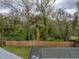 Fenced backyard with screened pool and wooded view at 2745 Horseshoe Dr, Plant City, FL 33566