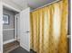 Bathroom with a yellow patterned shower curtain and tiled flooring at 2745 Horseshoe Dr, Plant City, FL 33566