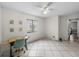 Bright bedroom with neutral tile flooring, ceiling fan, and desk at 2745 Horseshoe Dr, Plant City, FL 33566