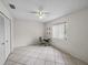 Bright bedroom with neutral tile flooring, ceiling fan, and closet at 2745 Horseshoe Dr, Plant City, FL 33566
