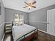 Comfortable bedroom with a ceiling fan, modern flooring and a bright window at 2745 Horseshoe Dr, Plant City, FL 33566
