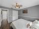 Comfortable bedroom featuring a ceiling fan, wood floors, closet, and a neutral color scheme at 2745 Horseshoe Dr, Plant City, FL 33566