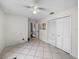 Spacious bedroom with tiled floor, featuring a large closet for ample storage space at 2745 Horseshoe Dr, Plant City, FL 33566