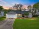 Charming single-story home with a well-manicured lawn, landscaping, and a two-car garage at 2745 Horseshoe Dr, Plant City, FL 33566