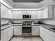 Well-lit kitchen featuring stainless steel appliances, white cabinets, and plentiful counter space at 2745 Horseshoe Dr, Plant City, FL 33566