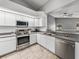 Bright kitchen with stainless steel appliances, white cabinetry and stone tile flooring at 2745 Horseshoe Dr, Plant City, FL 33566