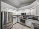 Efficient kitchen with stainless steel appliances, ample counter space, and sleek, white cabinets at 2745 Horseshoe Dr, Plant City, FL 33566