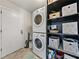 Convenient laundry room with stacked washer and dryer and built-in shelving at 2745 Horseshoe Dr, Plant City, FL 33566
