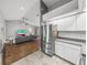 Open concept living room with hardwood floors, high ceilings, and stainless steel refrigerator at 2745 Horseshoe Dr, Plant City, FL 33566