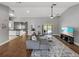 Spacious living room with wood-look floors, a view of the backyard, and ample natural light at 2745 Horseshoe Dr, Plant City, FL 33566