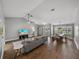 Bright living room with vaulted ceilings, entertainment center, gray sofa, and dining room views at 2745 Horseshoe Dr, Plant City, FL 33566