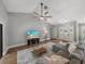 Bright living room with a neutral palette, a large fan, and a view of the entryway at 2745 Horseshoe Dr, Plant City, FL 33566