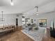 Spacious open-concept living room with dining area, modern furnishings, vaulted ceilings, and sliding door to the outdoor pool at 2745 Horseshoe Dr, Plant City, FL 33566