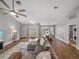 Open-concept living room with hardwood flooring, a ceiling fan, and comfortable seating at 2745 Horseshoe Dr, Plant City, FL 33566