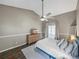 Inviting main bedroom features wood floors, a fan, neutral walls and ample natural light at 2745 Horseshoe Dr, Plant City, FL 33566