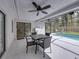 Outdoor patio with pool, BBQ grill, dining table and outdoor furniture, and ceiling fan at 2745 Horseshoe Dr, Plant City, FL 33566