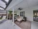 View of screened-in patio with wicker seating, ceiling fan, and a view of the backyard at 2745 Horseshoe Dr, Plant City, FL 33566