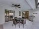 Covered patio featuring a ceiling fan, outdoor dining set, and a stainless steel grill at 2745 Horseshoe Dr, Plant City, FL 33566